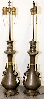 A Pair of Cast Metal Table Lamps Height 34 1/4 inches.