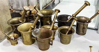 * Eleven Brass Mortars and Pestles. Height of tallest 5 1/4 inches.
