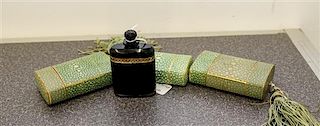 A Collection of Shagreen Printed Cardboard Perfume Holders and One Bottle, France. Height of bottle 3 inches.