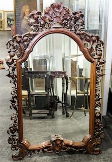 * A Victorian Style Mahogany Carved Mirror. Height 53 x width 35 inches.