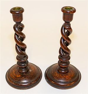 A Pair of English Oak Candlesticks Height 10 1/4 inches.