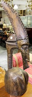 A Bambara Metal Mounted and Carved Wood Headdress Height 38 1/4 inches.