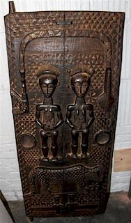 A Dogon Carved Wood Granary Door Height 56 3/4 x width 22 1/2 inches.