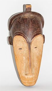 * A Gabon Wood Mask, Ngi Society. Height 19 1/4 inches.