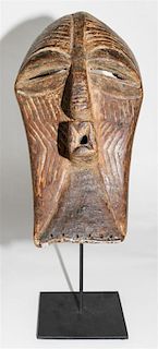 * A Songe Wood and Metal Mask. Height 15 inches.