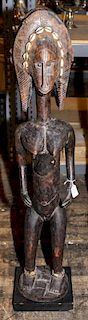 * A Bamana Carved Wood Figure of a Standing Female Height 41 1/2 x width 7 3/4 x depth 7 inches.