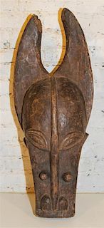 * A Senufo Cow Masque. Height 32 x width 14 inches.