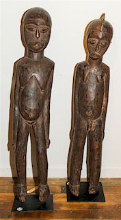 * An Igbo Carved Wood Couple. Height 34 x width 6 1/2 x depth 5 1/2 inches.