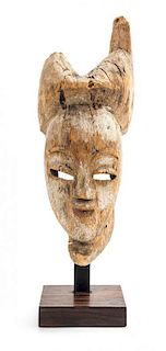 * An African Carved Wooden Masque. Height 12 1/2 x width 4 3/4 x depth 5 1/2 inches.