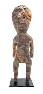 * An African Carved Wood Fetish Figure. Height 21 1/2 x width 6 x depth 5 1/2 inches.