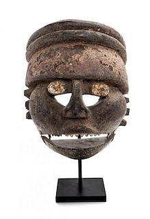 * A Nigerian Ibibio Wood Face Mask Height 12 x width 9 1/2 x depth 6 1/2 inches.