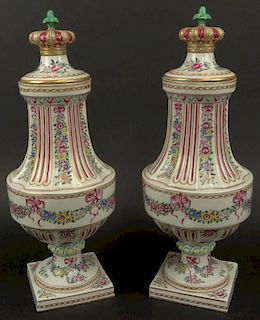 Pair of Early 20th Century French Louis XVI-style Painted Porcelain Urns with Crown Finials.