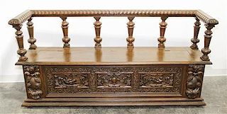 * A Continental Carved Walnut Hall Bench. Width 74 inches.