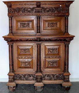 * A Continental Carved Oak Wardrobe. Height 81 x width 62 x depth 24 inches.