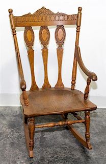 * A Victorian Pressed Oak Rocker Height 28 1/2 inches.