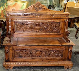 * A Victorian Carved Oak Hall Bench. Height 56 inches.