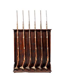 An English Style Mahogany Gun Rack, Height 57 x width 51 x depth 11 3/4 inches; overall height with rifles 83 inches.