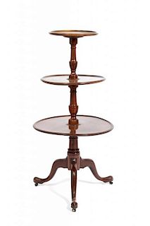 An English Mahogany Dumbwaiter, Height 45 1/4 x diameter of largest tier 22 inches.