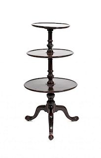 A Three-Tiered Mahogany Dumbwaiter, Height 41 1/2 x diameter of largest tier 21 inches.