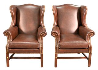 A Pair of Leather Upholstered Wing Chairs