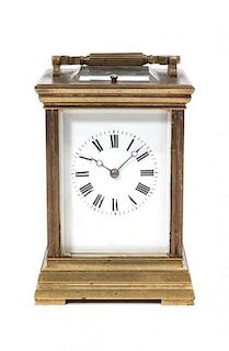 * A Brass and Glass Carriage Clock, Height over handle 7 1/2 inches.