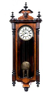 * A Vienna Mahogany and Part Ebonized Regulator Clock, Height 49 inches.