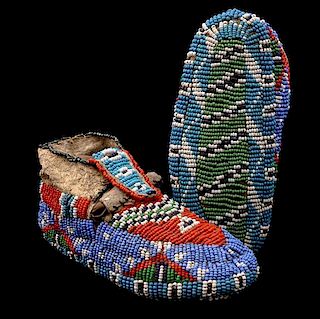 A Pair of Northern Plains Fully Beaded Child's Moccasins Length 5 inches.