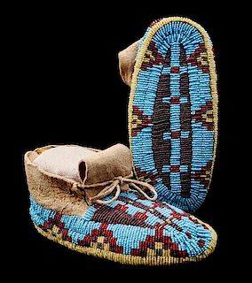 A Pair of Sioux Fully Beaded Child's Moccasins Length 6 inches.