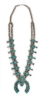 A Zuni Silver and Turquoise Petit Point Squash Blossom Necklace Length 22; height of naja 2 1/4 x width 2 inches.