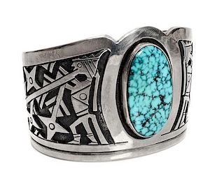 A Hopi Silver Overlay and Turquoise Mountain Bracelet, Victor Coochwytewa Length 5 1/2 x opening 1 1/8 x width 1 3/4 inches.