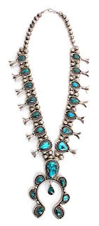 A Navajo Silver and Turquoise Squash Blossom Necklace Length 24 inches; height of naja 3 3/4 inches.