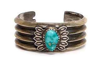A Navajo Sand-Cast Coin Silver and Turquoise Cuff Bracelet, Perry Shorty Length 5 3/8 x opening 1 1/8 x width 1 1/8 inches.