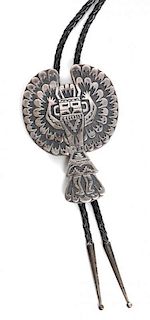 A Navajo Silver Bolo, Tommy Singer Height 3 5/8 x width 2 1/2 inches.