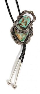 An Acoma Silver and Turquoise Bolo, Terrence Hunt Height 2 1/2 x width 2 1/4 inches.