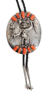 A Navajo Silver and Coral Bolo Height 3 7/8 x width 3 1/4 inches.