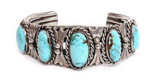 A Navajo Silver and Turquoise Bracelet Length 5 x opening 1 1/4 x width 7/8 inches.