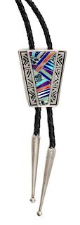 A Navajo Silver and Multiple Stone Bolo, Calvin Begay Height 1 5/8 x width 1 3/8 inches.