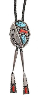 A Navajo Silver, Turquoise and Coral Bolo, Wilson Begay Height 2 1/2 x width 1 3/4 inches.