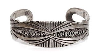 A Navajo Silver Bracelet, Richard Begay Length 5 1/8 x opening 1 x width 3/4 inches.