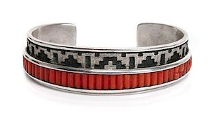 A Navajo Silver and Coral Bracelet, Dan Jackson Length 5 5/8 x opening 1 1/8 x width 3/4 inches.