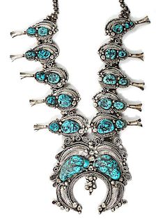 A Monumental Southwestern Silver and Turquoise Squash Blossom Necklace Length 32; height of naja 5 x width 6 inches.