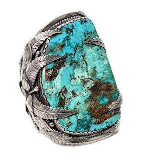 A Monumental Silver and Turquoise Bracelet Length 5 1/2 x opening 1 1/2 x width 4 3/4 inches.
