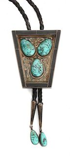 A Southwestern Silver, Turquoise and Onyx Bolo Height 2 3/4 x 2 1/4 inches.