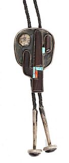 A Southwestern Silver, Ironwood, Turquoise and Coral Bolo Height 3 1/2 x width 2 1/8 inches.