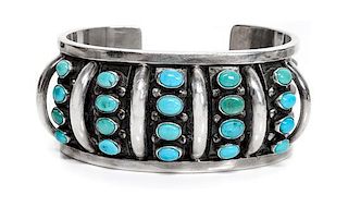 A Southwestern Silver and Turquoise Bracelet Length 5 1/2 x opening 1 x width 1 3/8 inches.