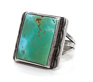 A Southwestern Silver and Turquoise Ring Height 3/4 x width 7/8 inches.