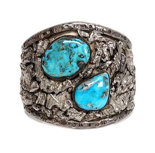 A Southwestern Silver and Turquoise Cuff Bracelet Length 5 3/4 x opening 1 1/4 x width 2 1/4 inches.