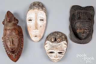 Four carved tribal African masks
