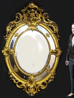 A Monumental French Hand Curved Wood Figural Mirror