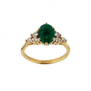 Gold ring with emerald and diamonds.